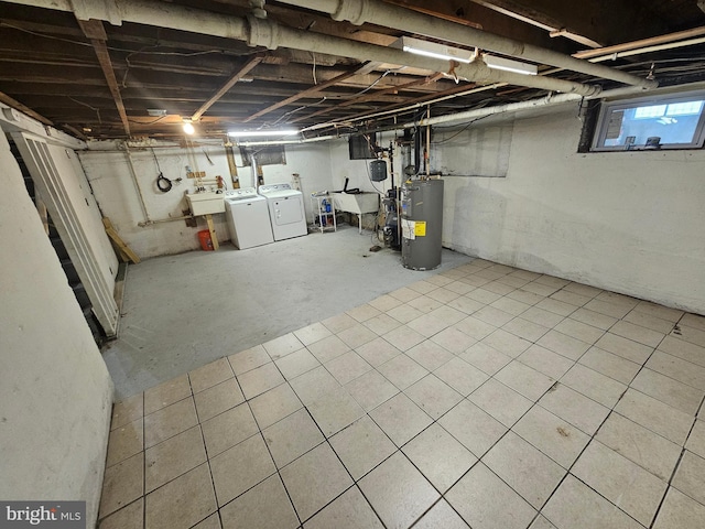 basement featuring sink, water heater, and washer and dryer