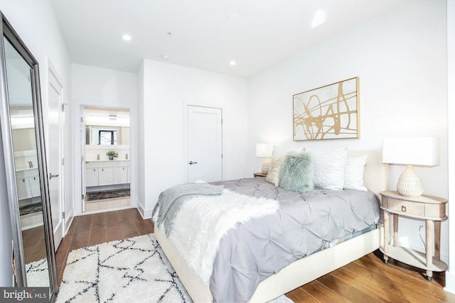 bedroom featuring dark wood-type flooring and ensuite bathroom