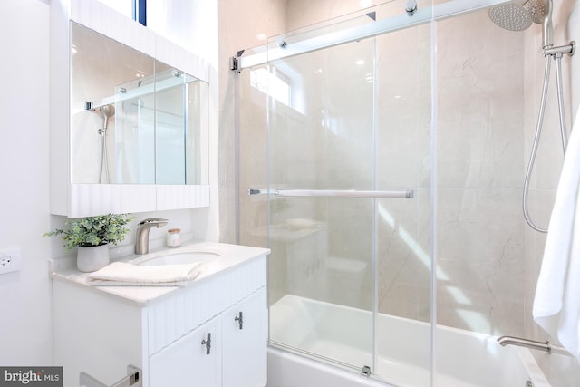 bathroom featuring enclosed tub / shower combo and vanity