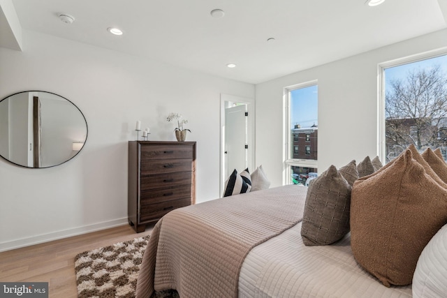 bedroom featuring light hardwood / wood-style floors and multiple windows