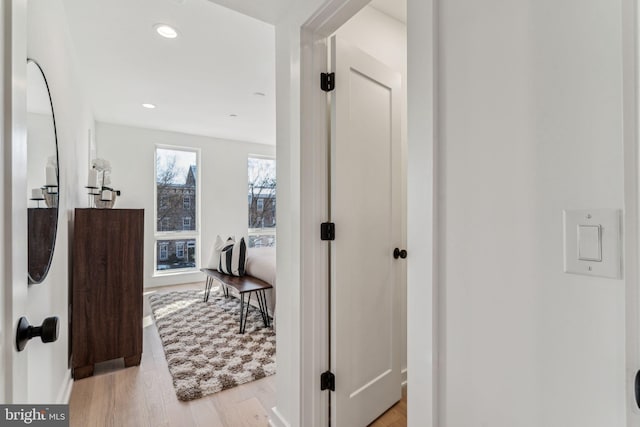 corridor with light hardwood / wood-style floors