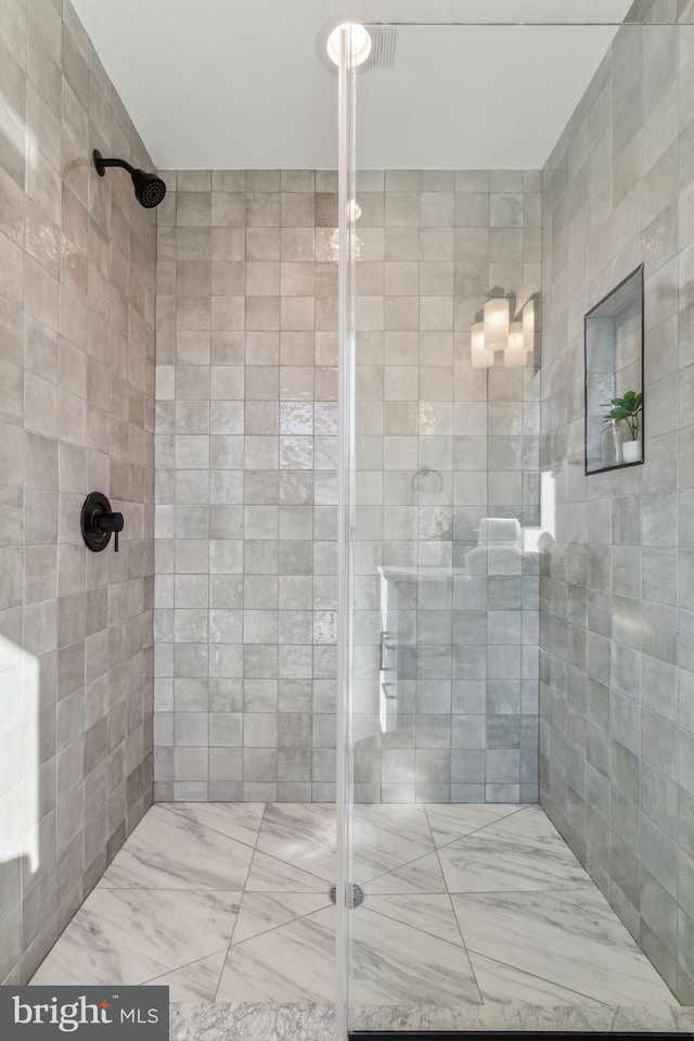 bathroom with a shower with shower door