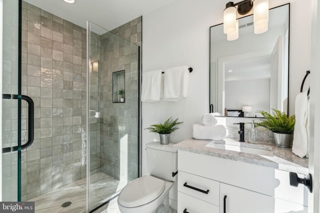 bathroom with vanity, toilet, and walk in shower