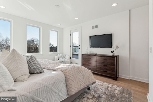 bedroom featuring light wood-type flooring and access to exterior