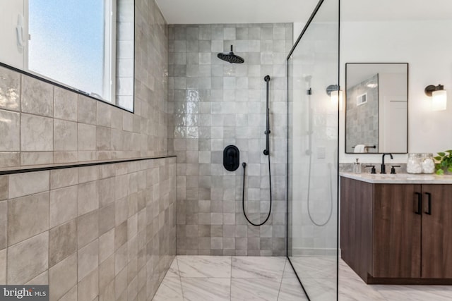 bathroom featuring vanity and tiled shower