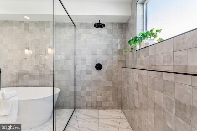 bathroom featuring separate shower and tub