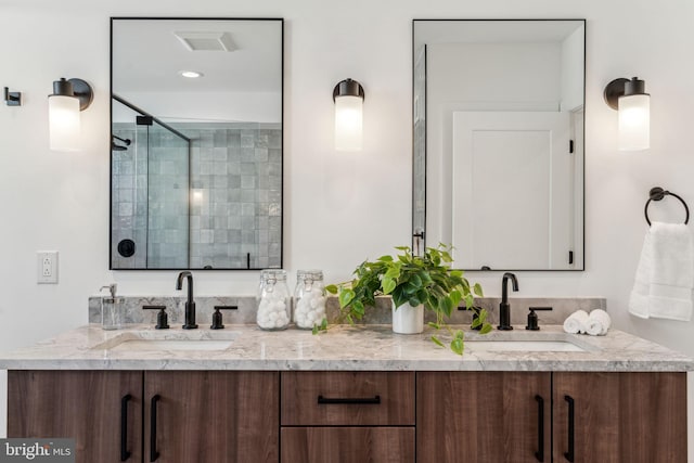 bathroom featuring an enclosed shower and vanity