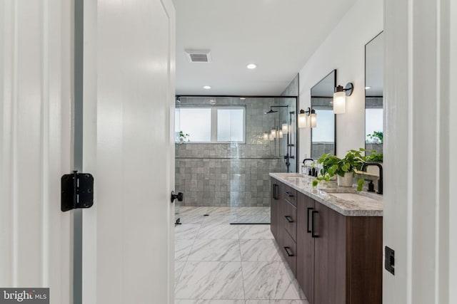 bathroom featuring plenty of natural light, an enclosed shower, and vanity