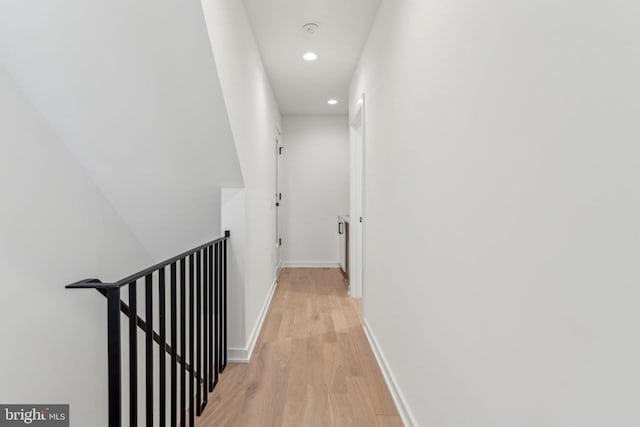 hallway with light hardwood / wood-style floors