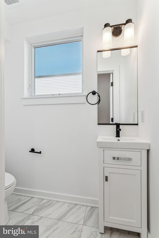 bathroom with toilet and vanity