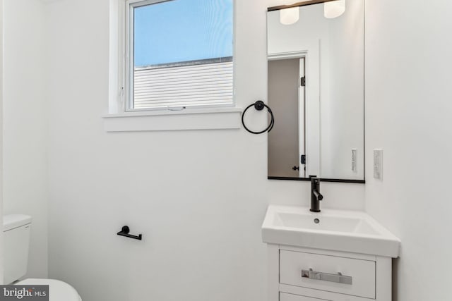 bathroom with toilet and vanity