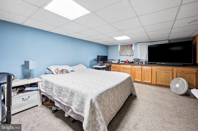 carpeted bedroom with a paneled ceiling