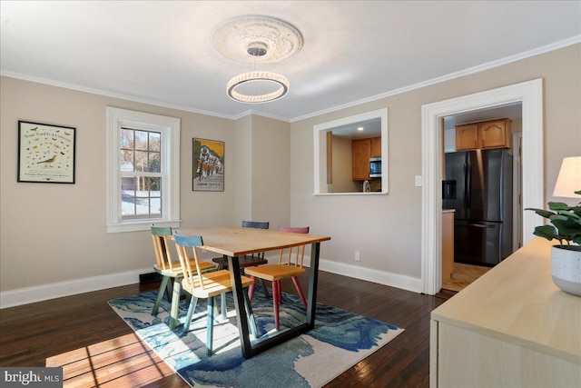 dining space with dark wood finished floors, baseboards, and ornamental molding