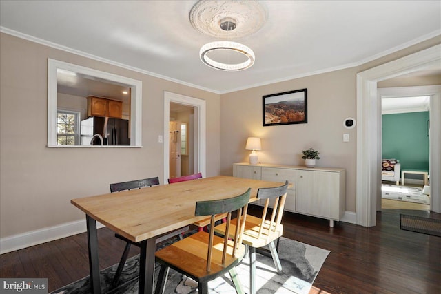 dining space featuring baseboards, crown molding, and dark wood-type flooring