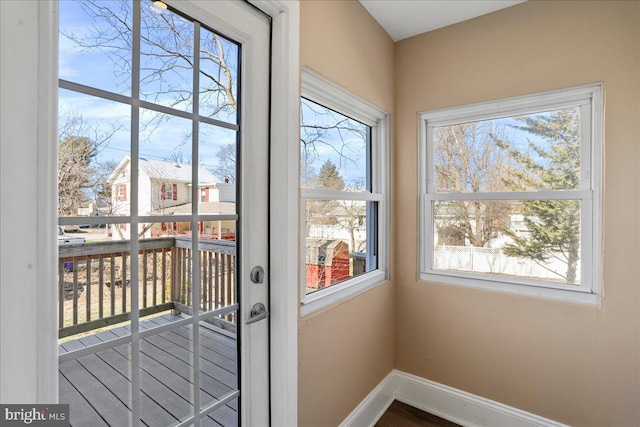 doorway featuring baseboards