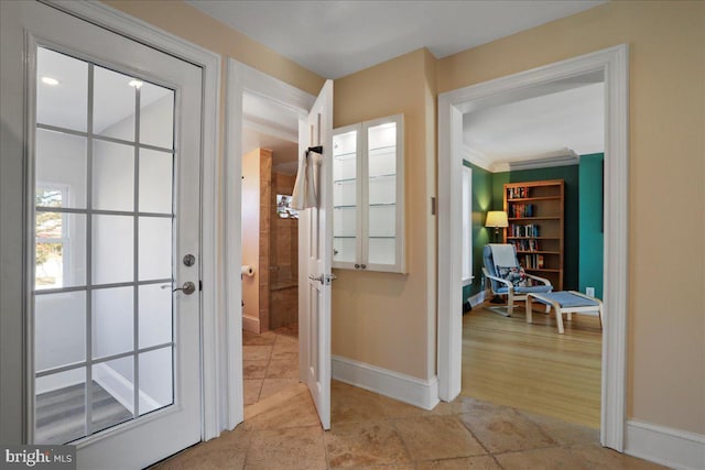 doorway with french doors and baseboards