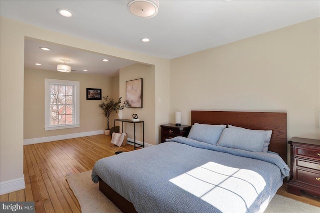 bedroom with recessed lighting, baseboards, and hardwood / wood-style floors