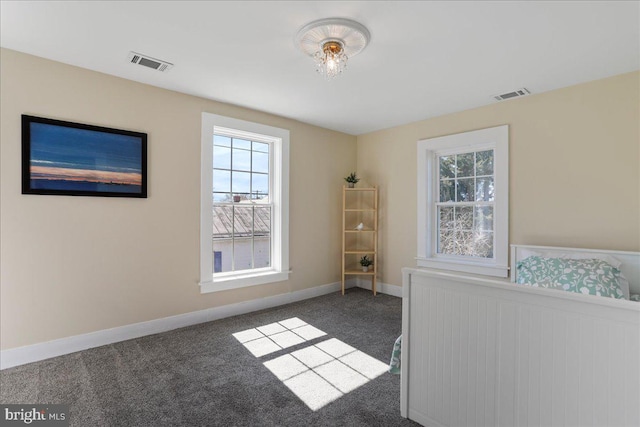 unfurnished bedroom featuring visible vents, carpet flooring, and radiator