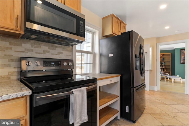 kitchen featuring stainless steel microwave, backsplash, black range with electric cooktop, baseboards, and fridge with ice dispenser