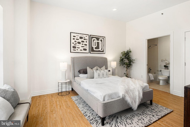 bedroom featuring hardwood / wood-style floors and connected bathroom