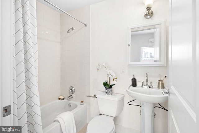 bathroom featuring toilet and shower / bath combination with curtain