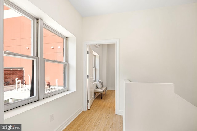 corridor with light hardwood / wood-style flooring