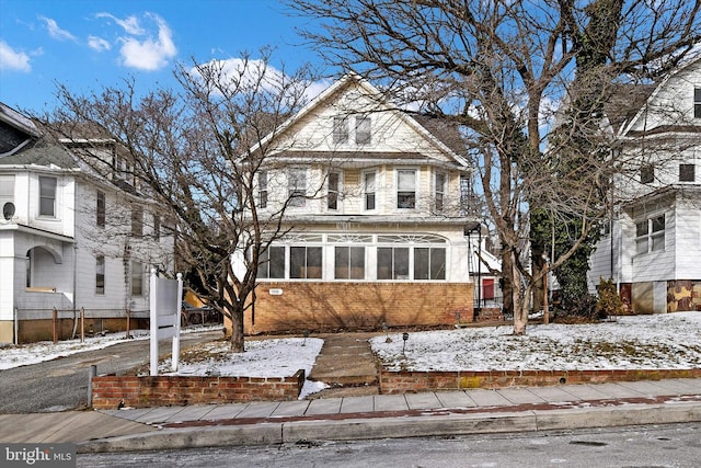 front facade with a sunroom