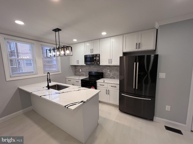 kitchen featuring black appliances, decorative light fixtures, white cabinetry, sink, and kitchen peninsula