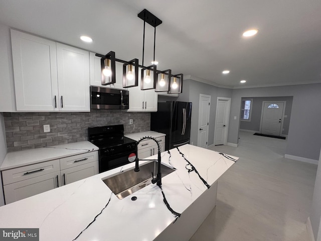 kitchen with backsplash, hanging light fixtures, black appliances, white cabinets, and sink