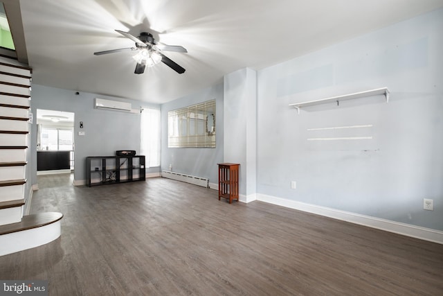 unfurnished living room with dark wood-type flooring, baseboard heating, a wall unit AC, and ceiling fan