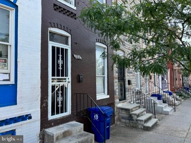 view of exterior entry with brick siding