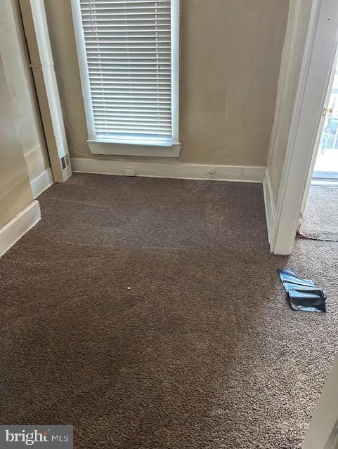 interior space with carpet floors and baseboards