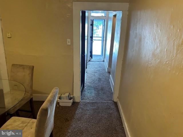 hall with carpet flooring and baseboards