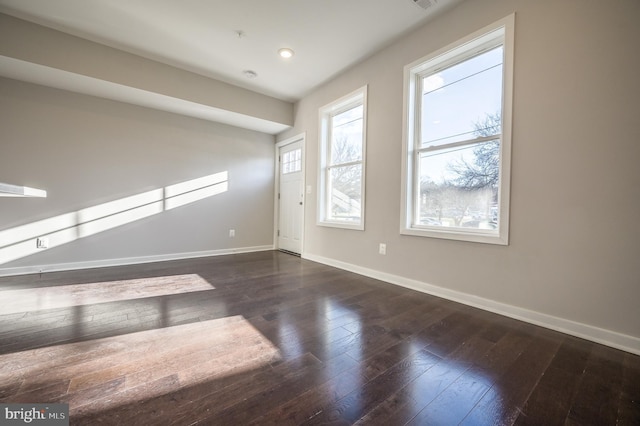 spare room with dark wood-type flooring