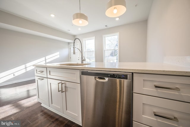 kitchen with dishwasher, pendant lighting, sink, white cabinets, and dark hardwood / wood-style flooring