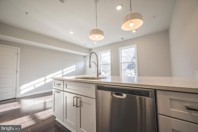 kitchen with light stone countertops, pendant lighting, dishwasher, dark wood-type flooring, and sink