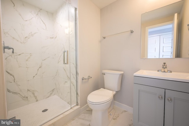 bathroom featuring toilet, a shower with door, and vanity