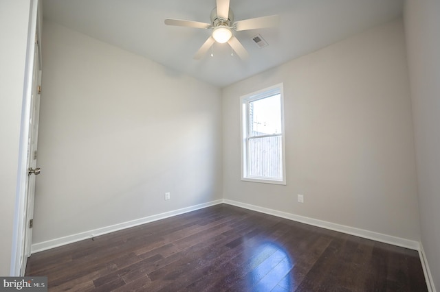 empty room featuring ceiling fan and dark hardwood / wood-style floors