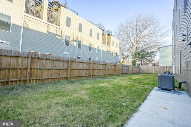 view of yard with central AC unit and a patio area