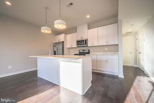 kitchen featuring white cabinets, a kitchen island with sink, appliances with stainless steel finishes, and pendant lighting