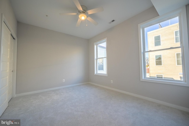 unfurnished room featuring ceiling fan and light carpet