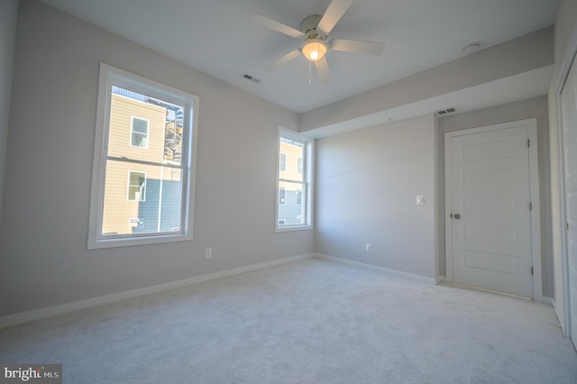 carpeted spare room featuring ceiling fan