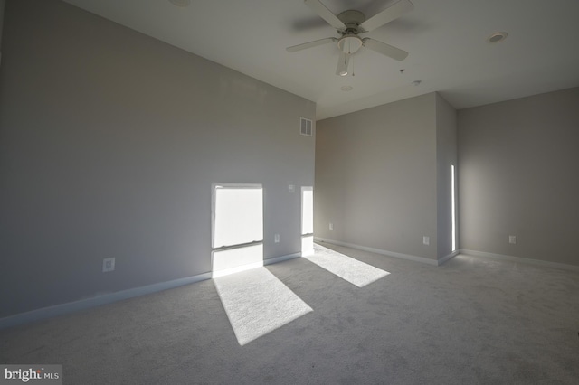 unfurnished room with ceiling fan and light colored carpet