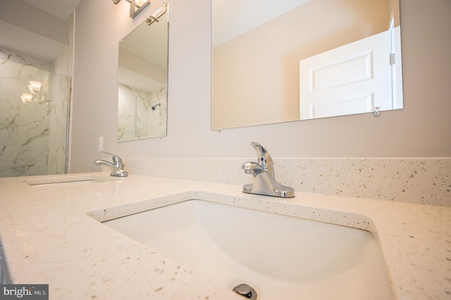 bathroom featuring walk in shower and vanity