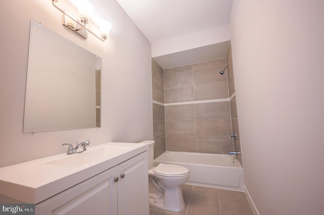 full bathroom featuring toilet, vanity, tiled shower / bath, and tile patterned flooring