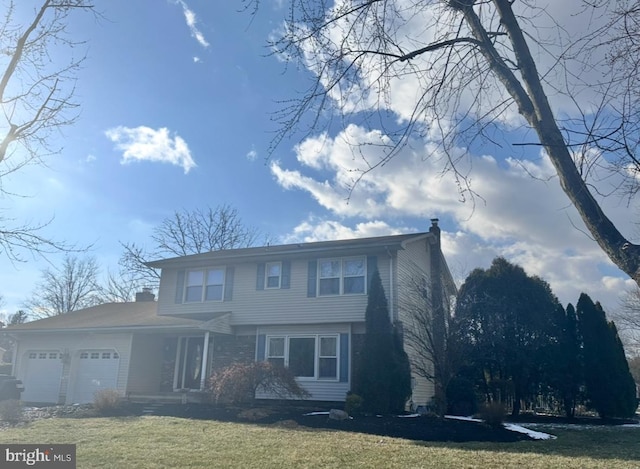 view of front property featuring a garage and a front lawn