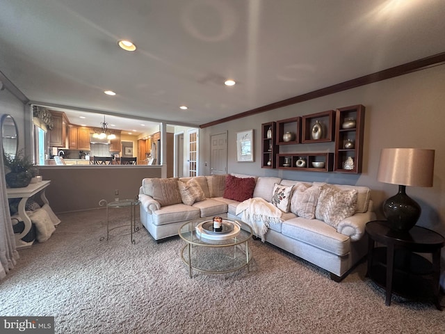 living room with ornamental molding and light colored carpet