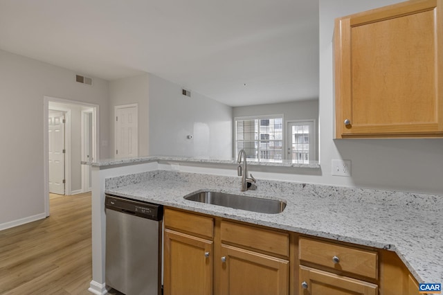 kitchen featuring stainless steel dishwasher, kitchen peninsula, sink, light wood-type flooring, and light stone counters