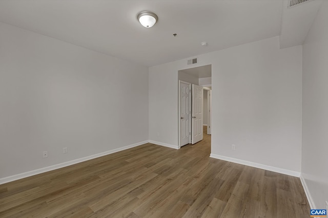 unfurnished room with hardwood / wood-style flooring