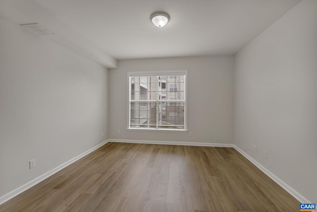 empty room with light hardwood / wood-style floors